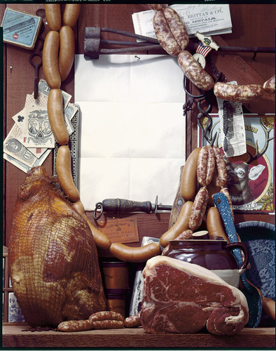 Display of butcher's meats with an advertising blank