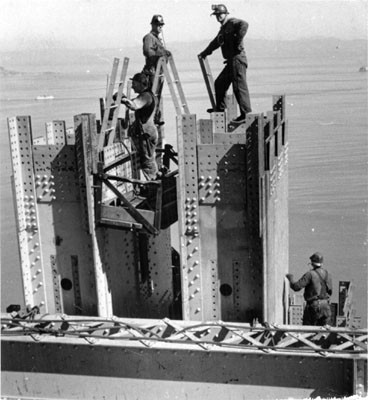 [Construction workers at top of Golden Gate Bridge north tower]