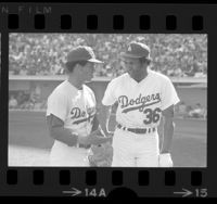 Dodgers Maury Wills and Frank Robinson talking during game in 1972