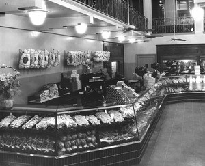 Inside a grocery displaying meat counter, deli