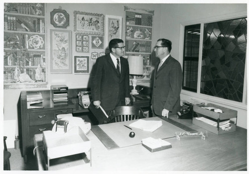 James C. Moore and guest in his office, circa 1964