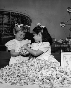 Los Angeles Orphanage orphans play in a pile of taffy at the Nu-Pike, 1950