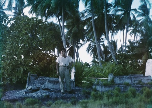 Richard Y. Morita, a microbiologist at the Scripps Institution of Oceanography, shown here in a island graveyard during a break from the Midpac Expedition (1950). 1950