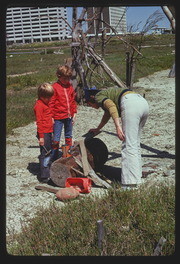 MAY75P7-16: woman with two children building a sculpture
