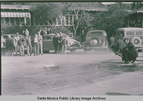 Fireman demonstrating how to extinguish phosphorus bombs in the event of an attack at Assembly Camp, Temescal Canyon, Calif