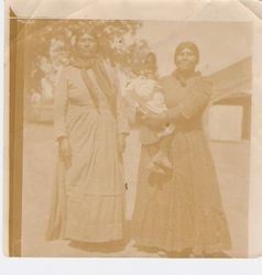 Two Native women with child in western dress at hop ranch