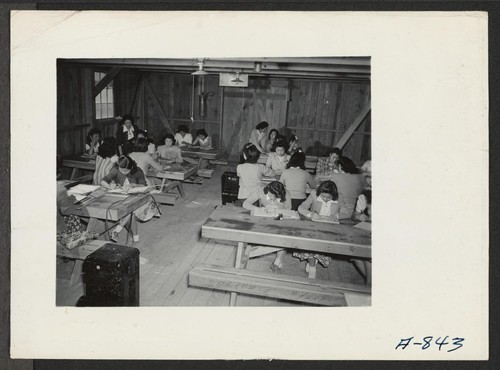Sewing school. Evacuee students are taught here not only to design but make clothing as well. Photographer: Stewart, Francis Poston, Arizona