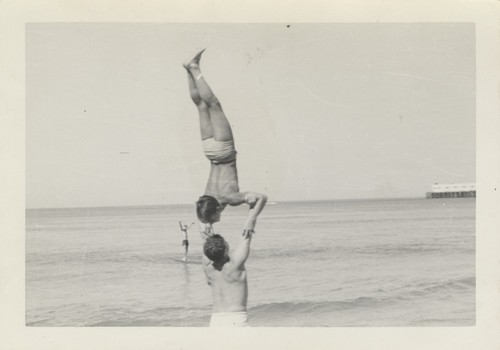 Harry Murray holding Lloyd Hooper in a handstand at Cowell Beach