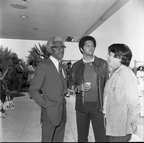 Bayard Rustin talking with two unidentified men, Los Angeles, 1973