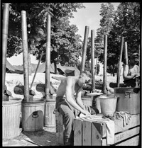 [Recovered Allied Military Personnel, RAMPs: (former?) prisoners of war washing dishes in camp]