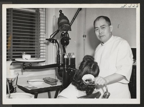 Dr. Milton Honda, Issei evacuee from the Tule Lake Relocation Center, is shown here in his dental office, which he