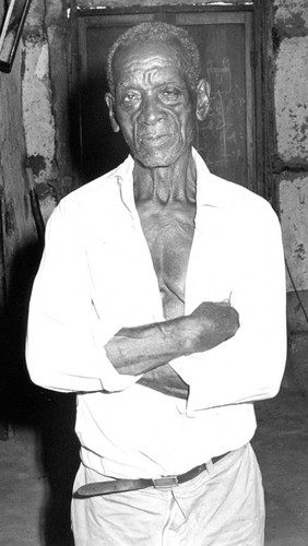 Man standing inside a home, San Basilio de Palenque, 1976