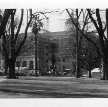 Exterior view of the California State Capitol Annex under construction. This view is taken in the park from 13th Street