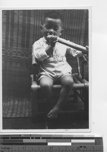 A little boy eating sugar cane at Ducheng, China, 1936