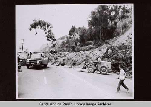 Trucks clearing landslide debris from Pacific Coast Highway, Santa Monica, Calif., August 1956