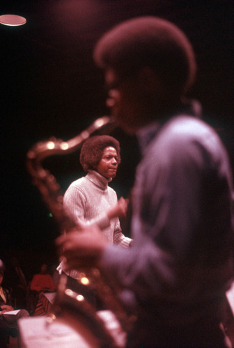 Troy Robinson with saxophone player in foreground