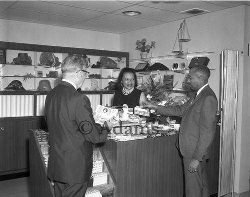 Woman at cash register, Los Angeles, 1964
