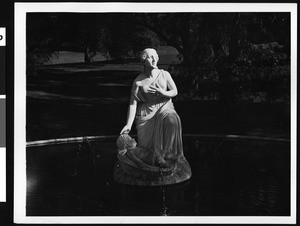View of a white marble statue of pharoah's daughter and Moses in a fountain at Forest Lawn, Glendale, 1930-1950