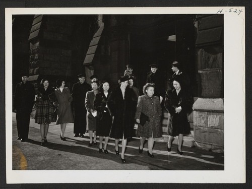 After Sunday church services with their Caucasian friends, the Niseis leave for a stroll along Michigan Boulevard in Chicago. Chicago Nisei like to go to church and here is a group which just attended Sunday services at the Second Presbyterian Church. Photographer: Mace, Charles E. Chicago, Illinois