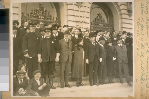 L to R, Front line: Capt. H. Gleeson and Chief of Police D.J. O'Brien - Center: Mr. Jas. Rolph and Mayor Jas. Rolph, Jr. - On the end of line Mrs. and Mr. Rosencrantz, Chairman of the Community Service Circus in front of the City Hall, Polk St. side, March 1922
