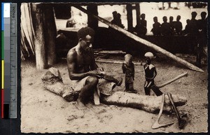 Indigenous man sculpting wooden statues, Solomon Islands, ca.1900-1930