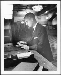 Student examining catalog card in Doheny Memorial Library, ca.1950s
