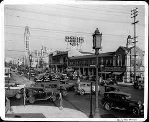 A high-angle view of the bustling activity of cars and pedestrians seen from the corner of Vermont Avenue and Wilshire Boulevard