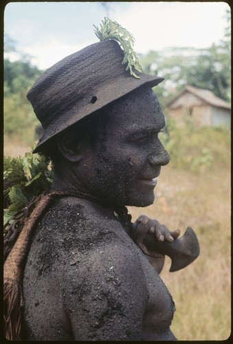 Basiitau painted black, wearing his very old cane hat