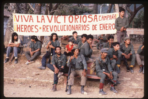 Guerrillas sitting in front of a political banner, La Palma, 1983
