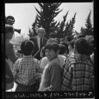 Composer-conductor Aaron Copland chatting with children following free Philharmonic concert for underprivileged youths in Los Angeles, Calif., 1972