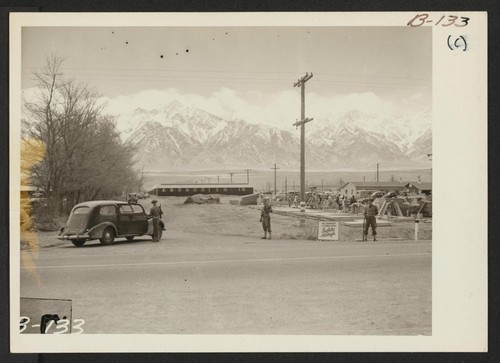Entrance, during construction, of this War Relocation Authority center for evacuees of Japanese ancestry in Owens Valley, flanked by High Sierras and Mt. Whitney, United States' loftiest peak. Photographer: Albers, Clem Manzanar, California