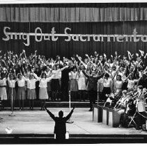 View of a choir "Sing Out Sacramento" performing at the California State Fair. This was the last fair held at the old fair grounds