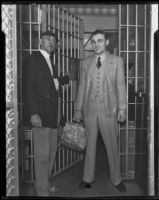 Accused murderer William James (Curly) Guy leaving jail after acquittal as Deputy Sheriff Swan Wilson opens the gate, Long Beach, 1933
