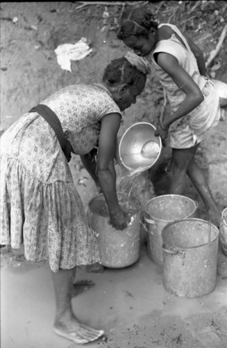 Woman collects water at river, San Basilio de Palenque, 1975