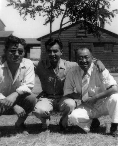 Dr. Taro Akamatsu with unidentified men in front of barracks at Tule Lake Relocation Center