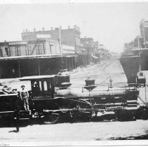 Central Pacific engine, A.A. Sargent, at J and Front Streets, 1865