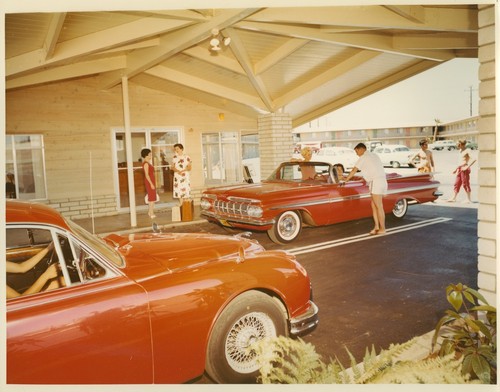Outdoor Main Entrance Area of the Oxnard MoteLodge with Cars and Guests