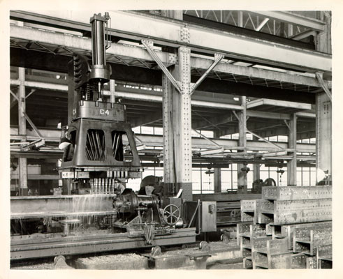 [L. R. Magness drilling a hole in a steel column being fabricated for the O'Connor, Moffatt & Company store in San Francisco]