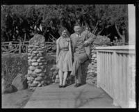 Woman and man seated on stone bench, Palisades Park, Santa Monica, [1930s?]
