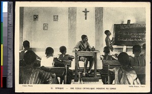 Indigenous teacher supervises student at a chalkboard, Congo Republic, ca.1900-1930