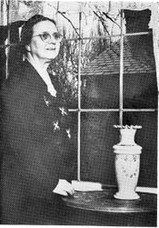 Mrs. Elizabeth Waters Burbank, widow of Luther Burbank, standing in her home in Santa Rosa in the Burbank Home and Gardens in 1949