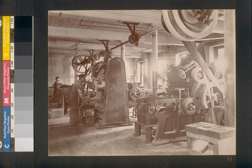 [Factory workers operating machinery.]
