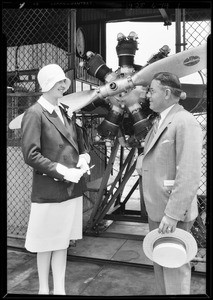 Lady Heath inspecting motor, Southern California, 1929