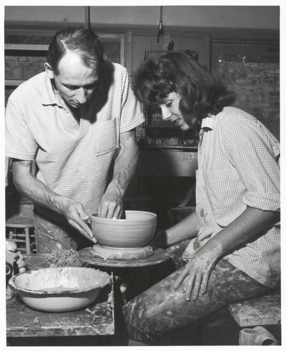 Paul Soldner and student with pottery wheel, Scripps College
