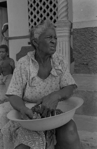 Woman sitting with bowl on her lap, San Basilio de Palenque, ca. 1978