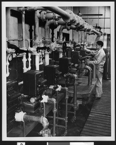 Shell Oil Company employee at work in the interior of the building, ca.1940