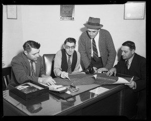 Belyea brothers in conference at desk, Southern California, 1940
