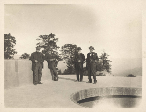 Wendell Hoge, Charles St. John, Ambrose Swasey and John A. Brashear, standing on pier for 100-inch telescope, Mount Wilson Observatory