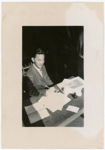 John Yoshinaga at desk