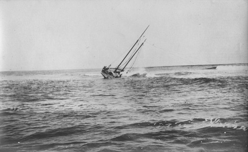 The "Loma" given to the Marine Biological Association of San Diego by E.W. Scripps for research purposes shown here run aground near the Point Loma lighthouse on July 25, 1906. The boat was caught by the breakers and carried up onto the rocky ledge that juts out from the point. When she could not be rescued everything was taken off the boat, including the copper sheathing and four tons of lead from the keel and she was abandon. The Association became the Scripps Institution of Oceanography. July 25, 1906